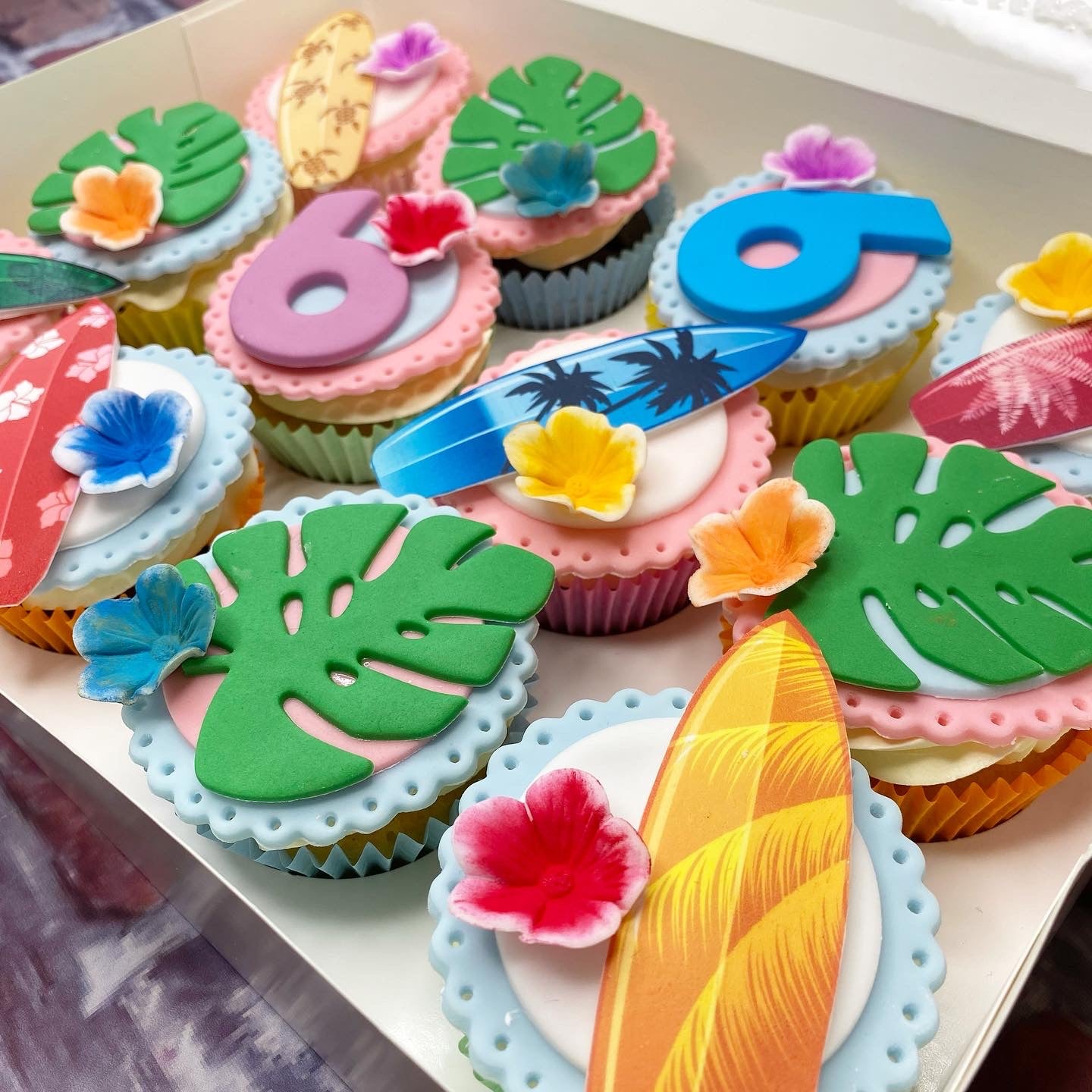 Decorative cupcakes with tropical-themed frosting 