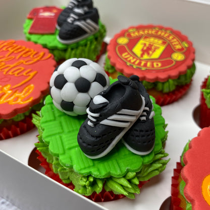 Cupcakes decorated with Manchester United logo and soccer elements