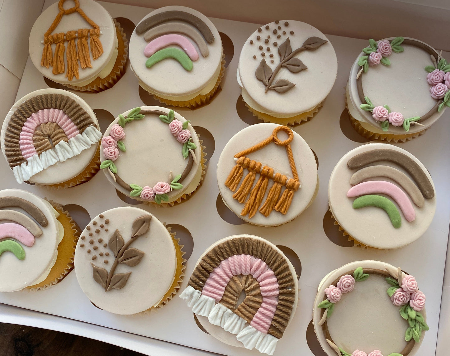 Decorative cupcakes with intricate designs in a box