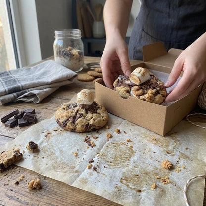 S’more cookie with toasted marshmallow being placed into a bakery box – New York bakery-style cookies by Sweet Bakery Dublin.