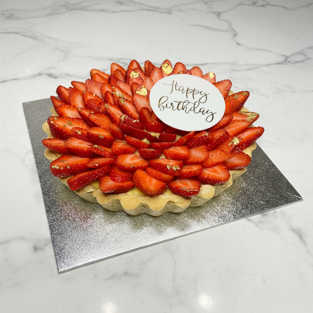 Strawberry tart with a 'Happy Birthday' 